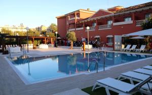a swimming pool in front of a building at Alborán Algeciras in Algeciras