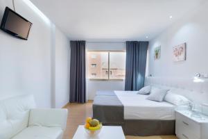 a hotel room with a bed and a couch at Boutique Urban Madrid Serrano in Madrid