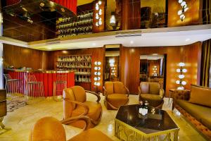a lobby with a library with chairs and a table at PALERİA hotel in Istanbul