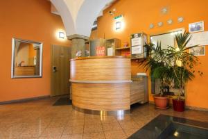 a restaurant with a wooden counter in a lobby at Hotel Prajer in Vodňany