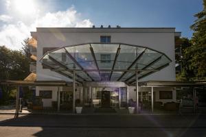 a large building with a large window in front of it at Apart-Hotel Zurich Airport in Opfikon