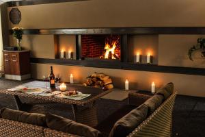 a living room with a fireplace and a table and chairs at RiverSide- Restaurant, Hotel, Beach in Chernihiv