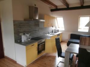 a kitchen with yellow cabinets and a counter top at Ferienwohnung Saaleblick in Halle an der Saale