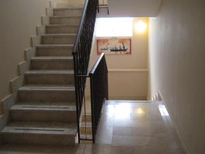 a stairway with a black railing and a stair case at Hotel San Martino in Cassibile
