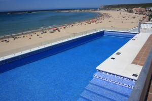 an overhead view of a swimming pool at a beach at Apartamentos Playa Barbate in Barbate