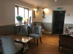 a waiting room with chairs and a table at The Elm Tree Inn in Wisbech