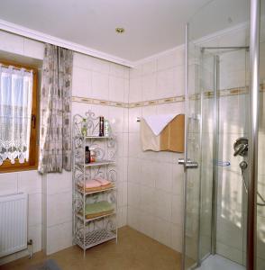 a bathroom with a shower and a glass shower stall at Haus Unterberg in Kössen