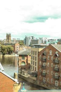 a view of a city with a river and buildings at Malmaison Hotel Leeds in Leeds