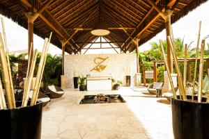 a living room with a fireplace in a resort at Grand Palladium Imbassaí Resort & Spa - All Inclusive in Imbassai