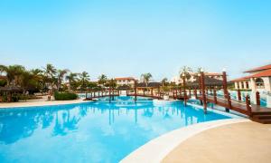 a large pool with blue water in a resort at Grand Palladium Imbassaí Resort & Spa - All Inclusive in Imbassai