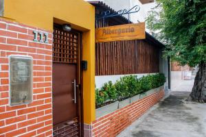 Una puerta a un edificio con un cartel. en Albergaria Hostel, en Fortaleza