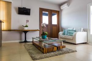 a living room with a couch and a coffee table at Hotel do Valle in Tijucas