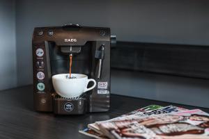 a coffee maker is making a cup of coffee at Malmaison Hotel Leeds in Leeds