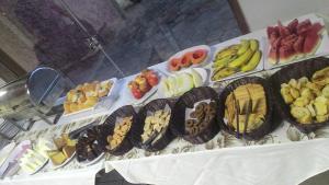 a table with many different types of food on it at Hotel Pinheiros in Chonim de Baixo