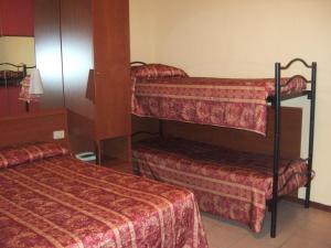 a room with two bunk beds in a room at Hotel Innocenti in Montecatini Terme