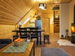 a living room with a table with a candle on it at Apartamenty 58 Czarny Groń in Rzyki