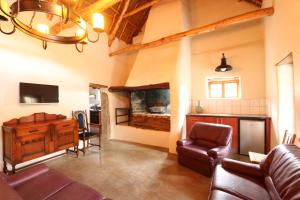 a living room with a couch and a table at Matjiesvlei Retreat Oudehuiskloof in Calitzdorp