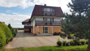 a house with a balcony on the side of it at Wieża nad Biebrzą in Dolistowo