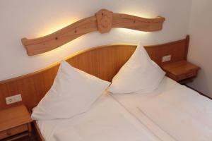 a bedroom with a bed with two pillows on it at Adler Post in Lenzkirch