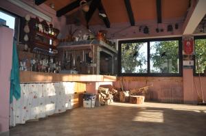 a large room with a counter in a building at Franko Apartmani in Zambratija