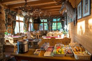 a restaurant with a table with food on it at Mountain Hotel Bilíkova Chata in Starý Smokovec