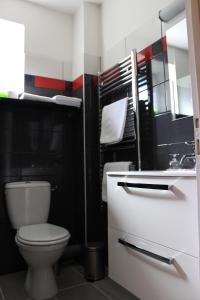a bathroom with a toilet and a sink at Hôtel BURLATIS in Sainte-Énimie