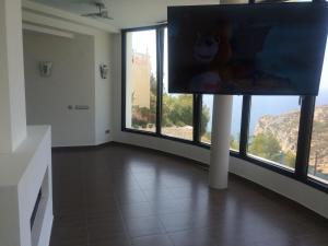 Televízia a/alebo spoločenská miestnosť v ubytovaní Villa Priscilla