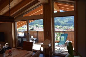 a dining room with a large glass window in a house at Chalet Christine in Brixen im Thale