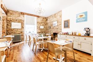 a restaurant with tables and chairs in a room at No4 St Ives in St Ives