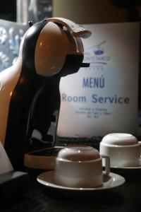 a coffee maker sitting on a table next to a cup at Hotel Montetaxco in Taxco de Alarcón