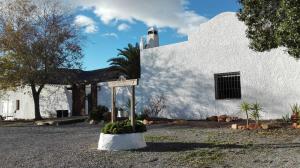 a white building with a sign in front of it at Alquería de Gítar in Félix