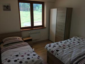 Posteľ alebo postele v izbe v ubytovaní Apartmán Donovaly, Panorama