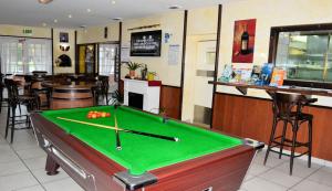 a pool table in a restaurant with a bar at Le Relax in Montaigu-Vendée