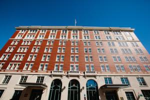 a tall red brick building with a flag on top at Hotel Julien Dubuque in Dubuque