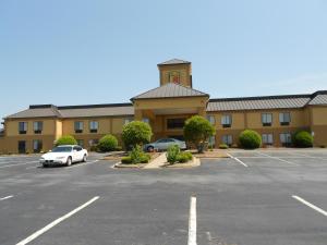 a parking lot in front of a building at Super 8 by Wyndham Piedmont Greenville Area in Piedmont