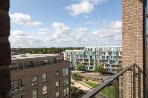 a view from the balcony of a apartment building at Exquisite & Homely Penthouse, 2 mins walk from Cambridge Station, Big balcony, lift access, secured gated on-site parking, self check-in & SUPER Fast WIFI in Cambridge