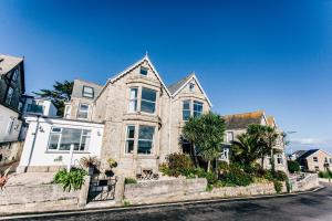 a large stone house with palm trees on a street at No4 St Ives in St Ives