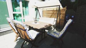 a wooden table and two chairs on a patio at Apartamenty na pięterku in Mielno
