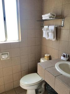 a bathroom with a toilet and a sink at Motel 6 Richmond CA Civic Center in Richmond