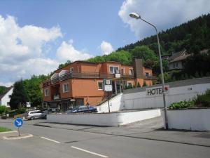 ein Haus am Straßenrand mit Straßenbeleuchtung in der Unterkunft Hotel Zur Rose in Bad Karlshafen