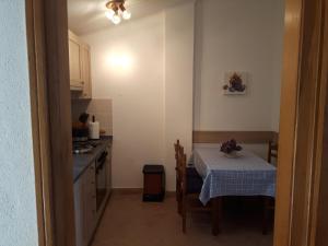 a small kitchen with a table and a table and a table and a table at Valun Seaside Apartments in Valun +56 photos