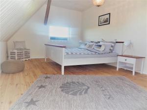 a bedroom with a bed and a table in it at Weitblick in Hasselberg