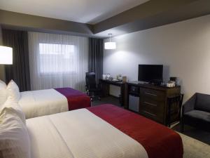 A bed or beds in a room at Best Western Plus Santa Cecilia Pachuca