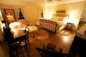 a bedroom with a bed and a table and chairs at Inn at Fox Hill Farm in Pomfret