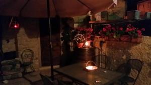 a table with two candles and an umbrella at b&b casamia in Molina