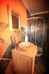 a bathroom with a sink and a shower at Nukakamma River Guesthouse in Colchester