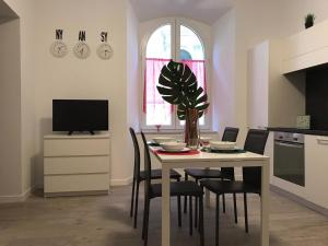 a kitchen with a table with chairs and a tv at Casa Ohana in Ancona