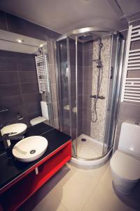 a bathroom with a shower and a toilet and a sink at Timhotel Paris Gare de l'Est in Paris