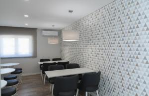 a room with tables and chairs and a brick wall at Casa Jerónimo B&B in Peso da Régua