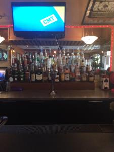 a bar with a lot of bottles of alcohol at Spring Villa Hotel in Harrison Hot Springs